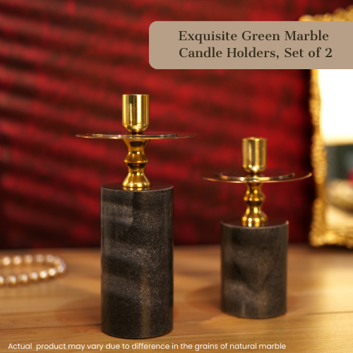 Elegant black and gold candlestick holders with lit candles on a wooden table.