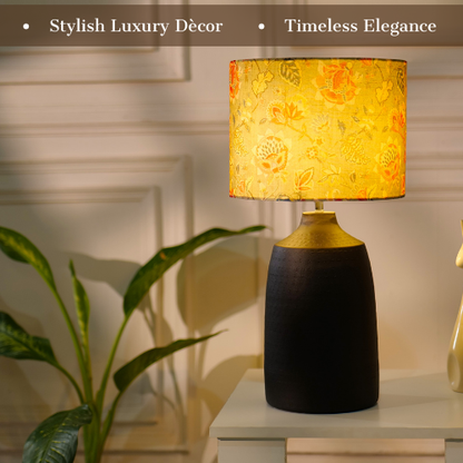 Elegant table lamp with colorful artistic shade on wooden base, placed on a desk