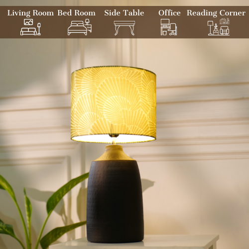 Elegant table lamp with colorful artistic shade on wooden base, placed on a desk