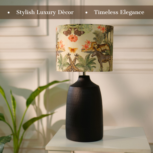 Table lamp with a dark, textured metal base and a floral-patterned fabric shade, placed on a white table in a room with plants