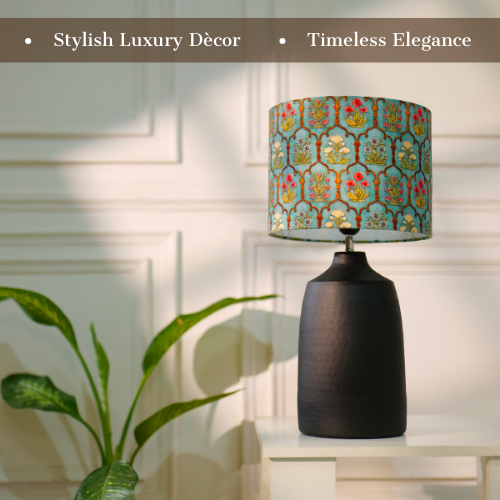 Elegant table lamp with colorful artistic shade on wooden base, placed on a desk