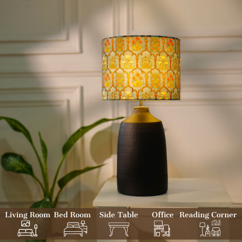 Elegant table lamp with colorful artistic shade on wooden base, placed on a desk