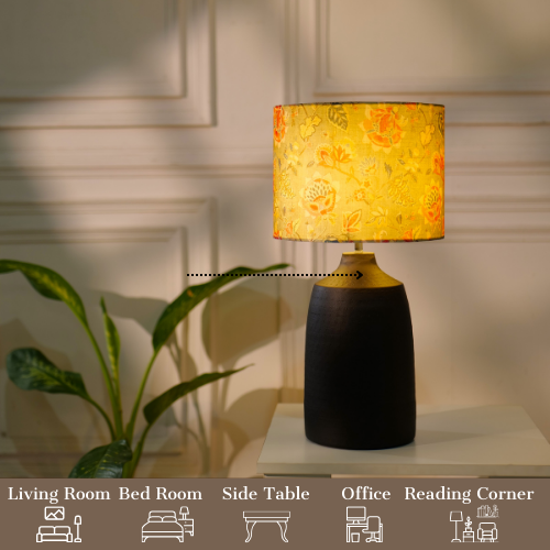 Elegant table lamp with colorful artistic shade on wooden base, placed on a desk