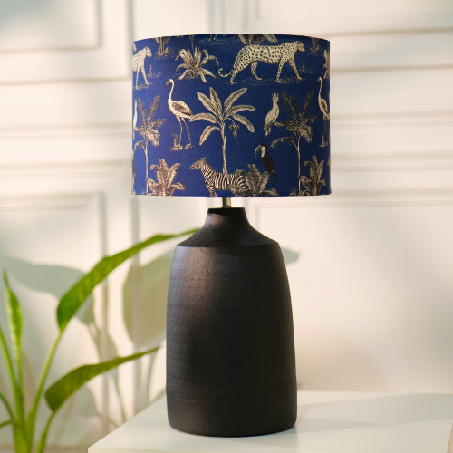 Elegant table lamp with colorful artistic shade on wooden base, placed on a desk